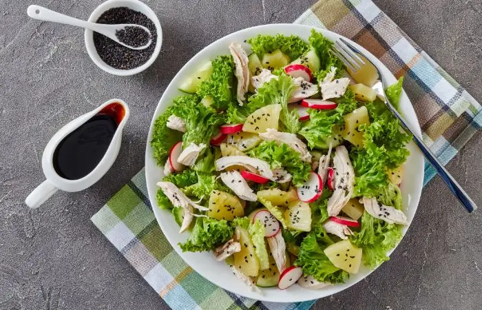 salad plate with chicken streps and pineapple