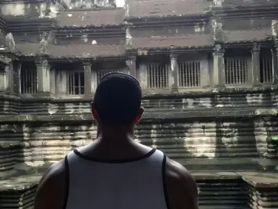 Rob Tatum looking into an ancient stone temple with sunlight streaming through the ruins.